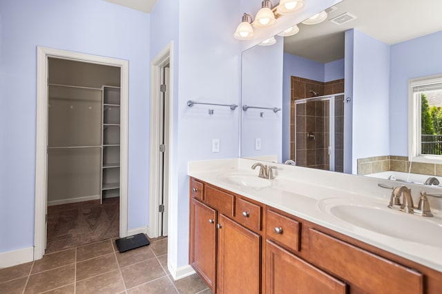 bathroom featuring double vanity, tile patterned flooring, and separate shower and tub