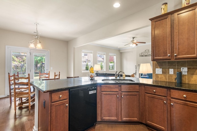 kitchen featuring black dishwasher, dark wood-style flooring, tasteful backsplash, a sink, and dark stone counters