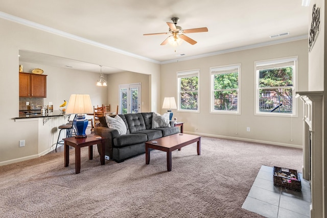 living room with carpet floors, visible vents, crown molding, and baseboards