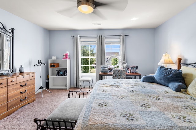 bedroom with ceiling fan and light carpet