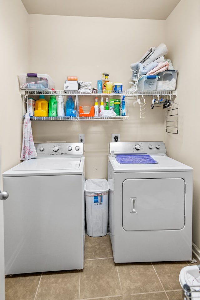 clothes washing area with light tile patterned flooring and independent washer and dryer