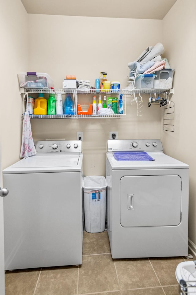 laundry room featuring washer and dryer, laundry area, and light tile patterned floors