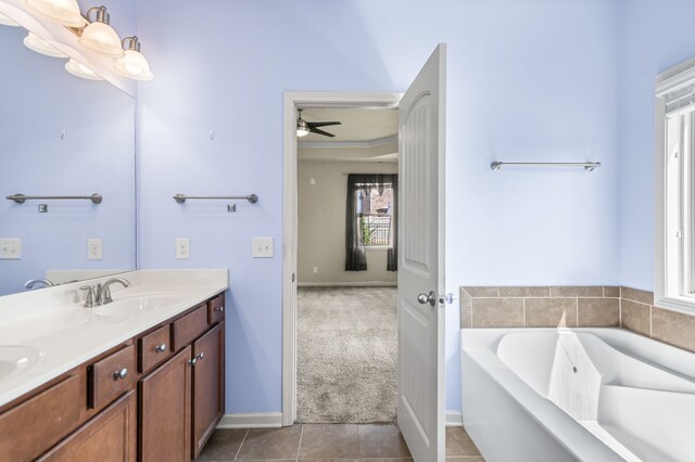 bathroom with ceiling fan, a bathing tub, tile patterned floors, and double sink vanity