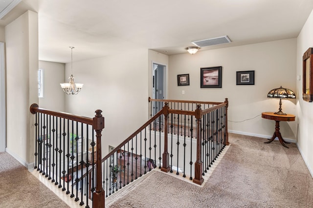 staircase featuring baseboards, carpet, visible vents, and an inviting chandelier