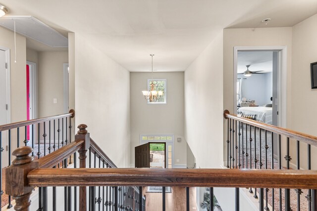 corridor featuring an inviting chandelier