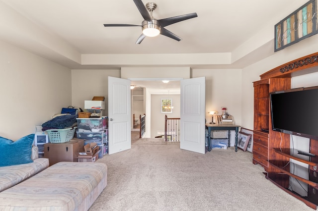 carpeted living room with ceiling fan