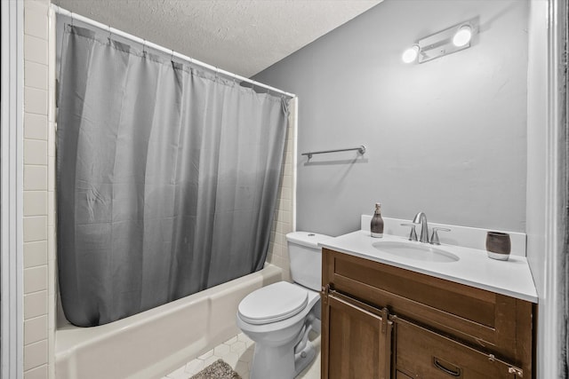 full bathroom featuring vanity, tile patterned floors, shower / bath combination with curtain, toilet, and a textured ceiling