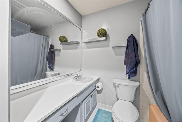 bathroom featuring tile patterned flooring, a shower with curtain, vanity, and toilet