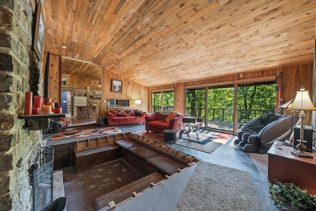 living room featuring a fireplace, wooden ceiling, vaulted ceiling, and wooden walls