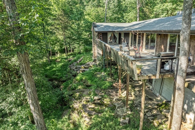 view of side of home featuring a wooden deck