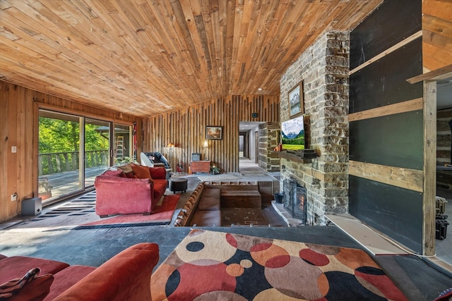 living room with a stone fireplace, wooden ceiling, wooden walls, and vaulted ceiling