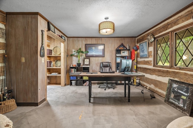 office area with a textured ceiling and wooden walls