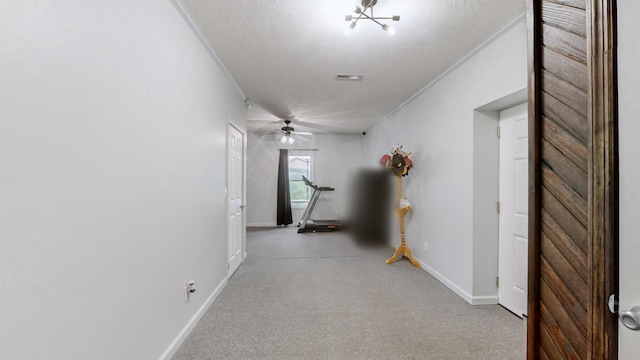 hall featuring crown molding, a chandelier, and a textured ceiling