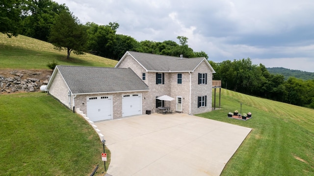 view of front of property with a garage and a front lawn