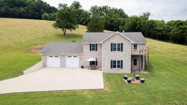 view of front of house with a balcony, a front yard, and a garage