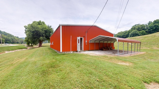 view of outbuilding featuring a carport and a lawn