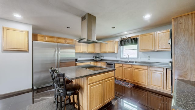 kitchen featuring sink, island range hood, a kitchen island, dark tile patterned flooring, and appliances with stainless steel finishes