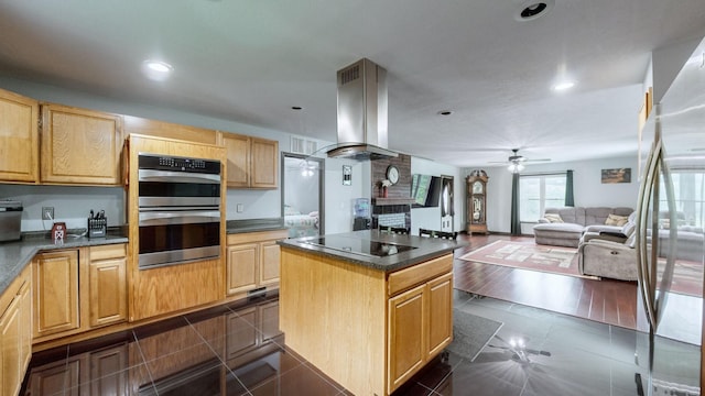 kitchen with light brown cabinets, a center island, exhaust hood, black electric stovetop, and dark hardwood / wood-style floors