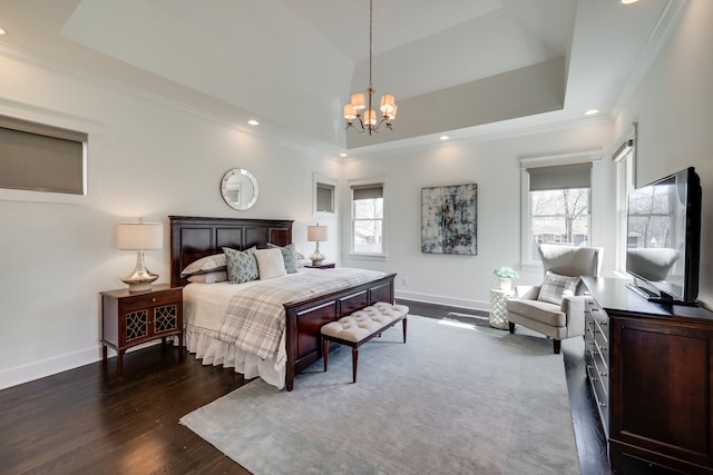 bedroom with dark hardwood / wood-style flooring, crown molding, a notable chandelier, and a raised ceiling