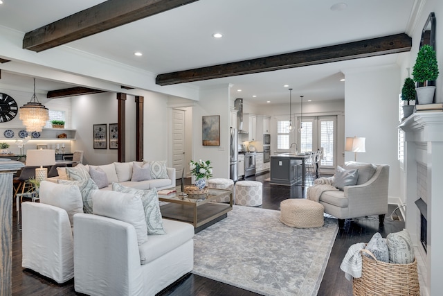 living room with beamed ceiling, sink, and dark wood-type flooring