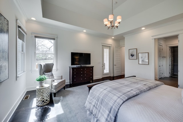 bedroom featuring a chandelier and a tray ceiling