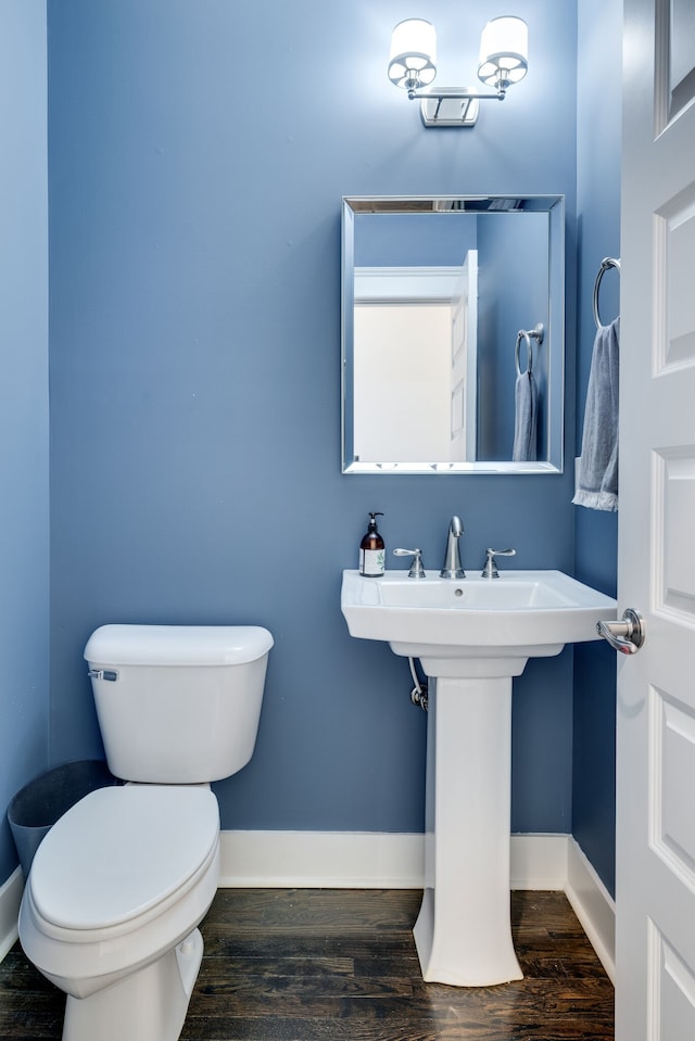 bathroom featuring hardwood / wood-style floors and toilet