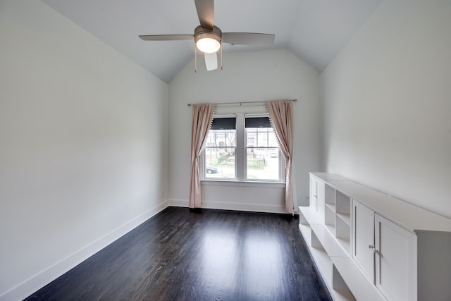 spare room with vaulted ceiling, dark hardwood / wood-style flooring, and ceiling fan