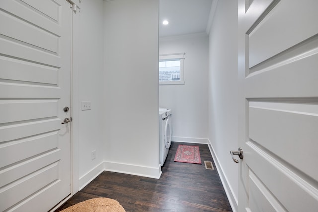 washroom featuring ornamental molding, separate washer and dryer, and dark wood-type flooring