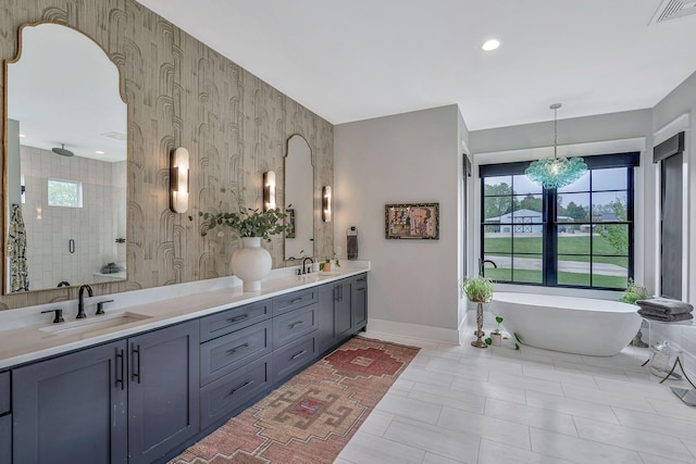 bathroom with vanity, tile patterned flooring, plus walk in shower, and an inviting chandelier