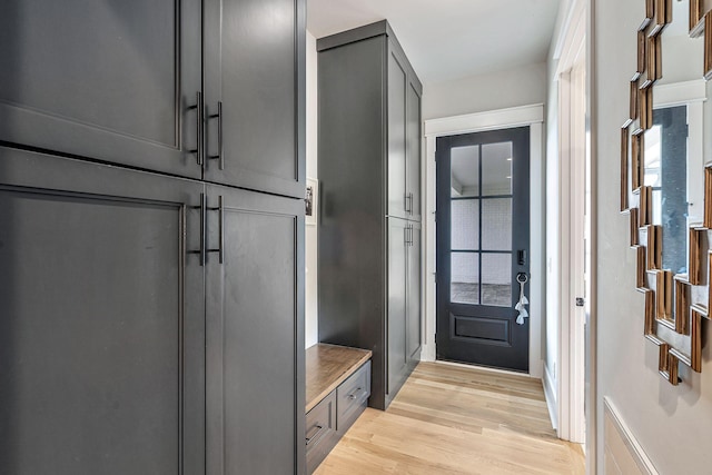 mudroom with light hardwood / wood-style floors