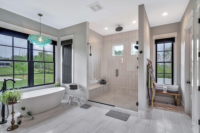 bathroom with tile patterned flooring and independent shower and bath