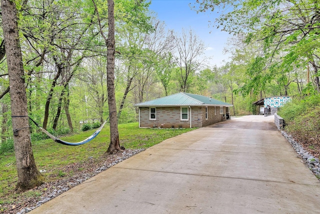 view of property exterior with a lawn