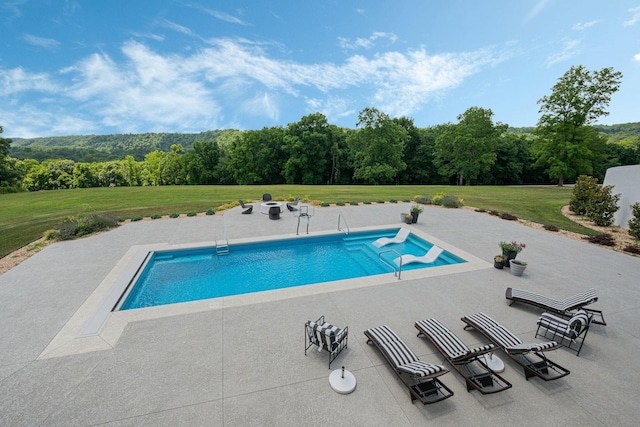 view of swimming pool with a lawn and a patio