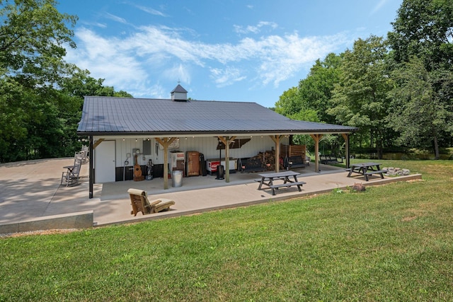 view of community featuring a patio and a lawn