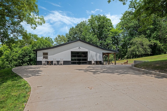 view of property exterior with an outbuilding