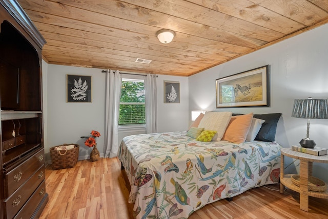 bedroom with crown molding, wooden ceiling, and light wood-type flooring