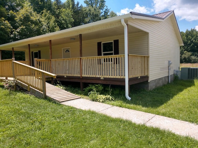 view of front facade with a front lawn and central air condition unit