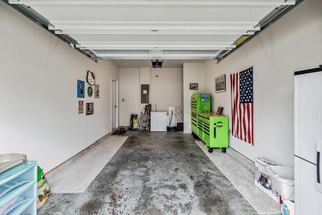 garage with electric panel and a garage door opener