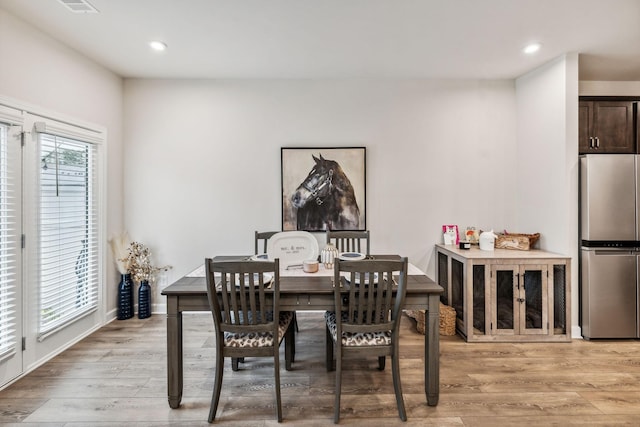 dining area with light hardwood / wood-style floors