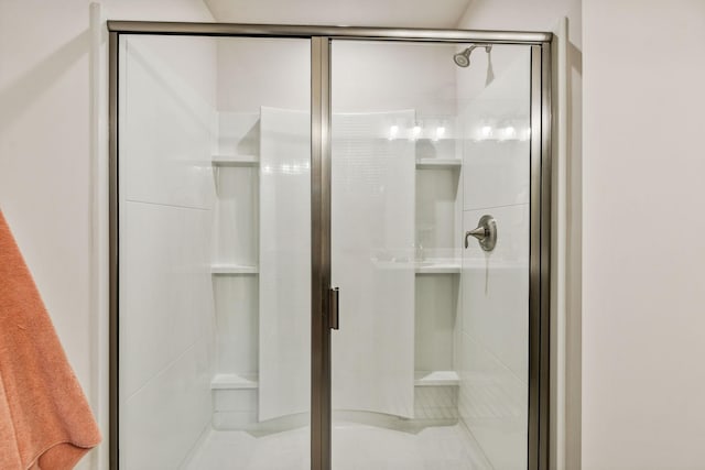 bathroom with tile patterned flooring and a shower with shower door