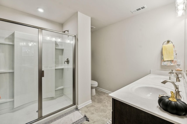 bathroom featuring tile patterned floors, vanity, an enclosed shower, and toilet