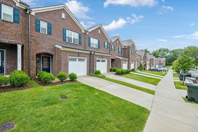 multi unit property with a garage and a front yard