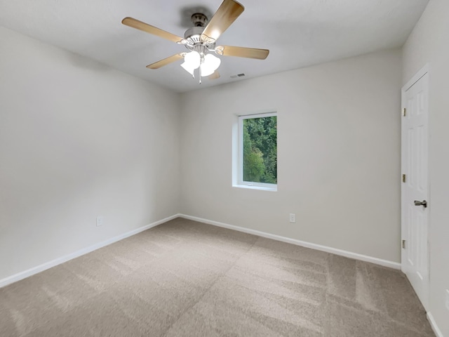 empty room featuring carpet, visible vents, and baseboards