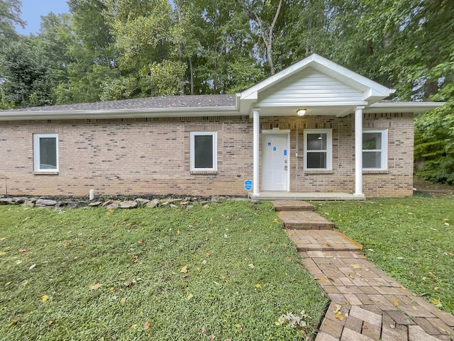 view of front facade with a front lawn and brick siding