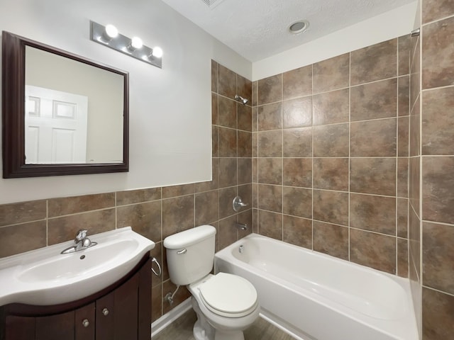 full bathroom with shower / washtub combination, vanity, toilet, and a textured ceiling