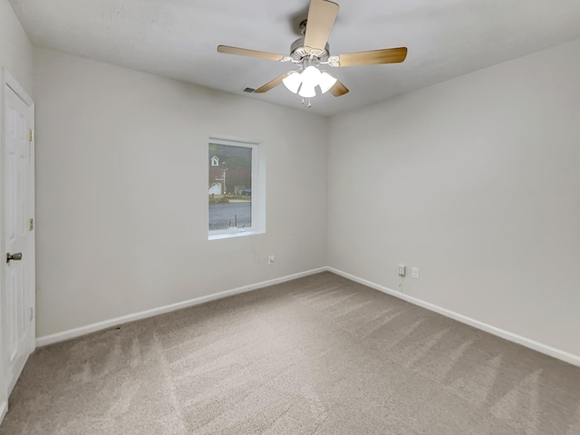 spare room featuring carpet flooring, ceiling fan, and baseboards