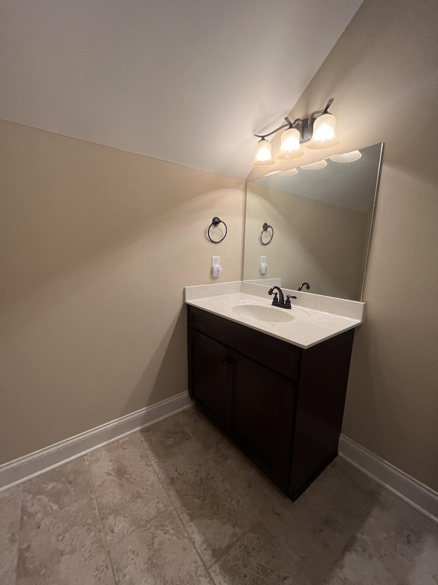 bathroom featuring vanity and lofted ceiling