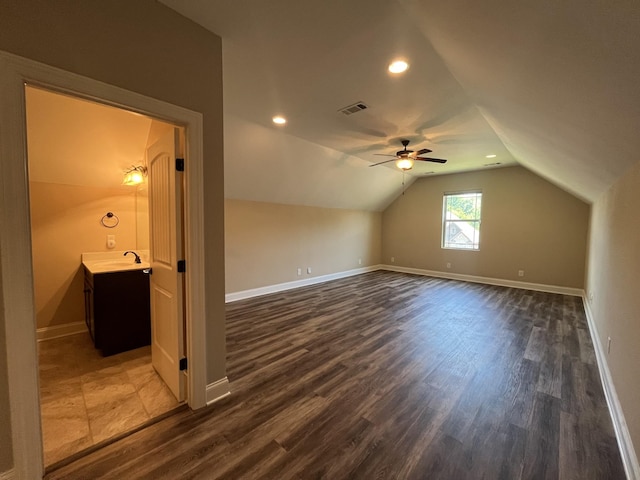 bonus room featuring vaulted ceiling, ceiling fan, dark wood-type flooring, and sink