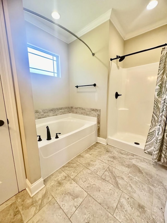 bathroom with ornamental molding and independent shower and bath