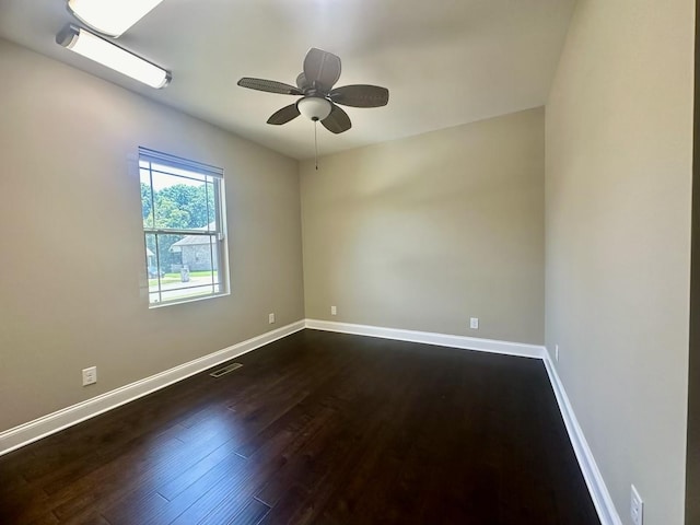 spare room with ceiling fan and dark hardwood / wood-style flooring